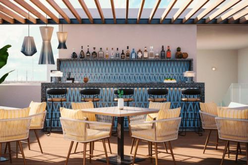 a restaurant with a table and chairs and a bar at abba Suites Playa del Carmen in Playa del Carmen