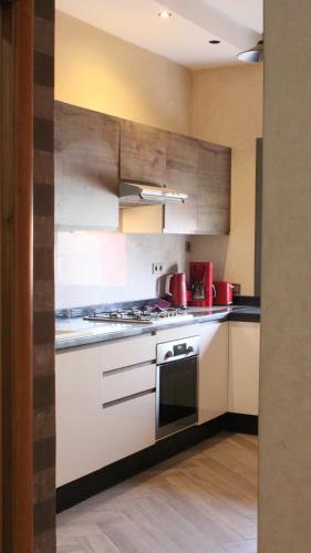 a kitchen with white cabinets and a stove top oven at Beautiful 2 bedrooms apartment in Agadir
