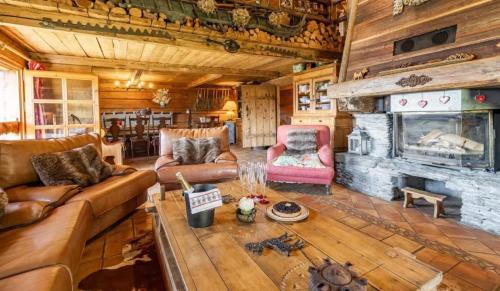 a living room with a couch and a fireplace at Chalet spacieux à Saint-Nicolas-la-Chapelle avec cheminée in Saint-Nicolas-la-Chapelle