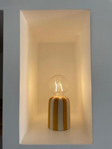 a yellow and white perfume bottle in a box at Studio cosy & rénové, à deux pas de la gare in Sallanches