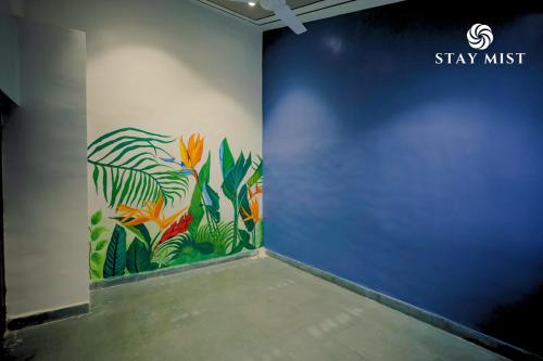 a wall with a painting of flowers on it at Pearl Castle Villa I Staymist in Nagaon
