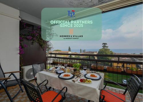 a table with plates of food on top of a balcony at Marriott CIAO LAGO Family Apartment DesenzanoLoft Official Partner Homes & Villas by Marriott Bonvoy in Desenzano del Garda