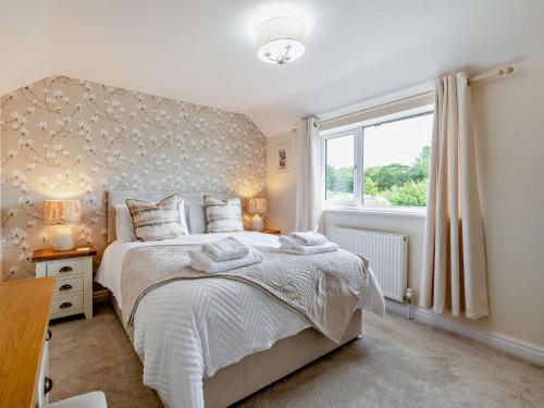 a bedroom with a large bed and a window at 2 Bed in Kirkbymoorside 92635 in Kirkbymoorside