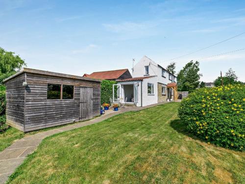 a small house with a yard next to a house at 2 Bed in Kirkbymoorside 92635 in Kirkbymoorside