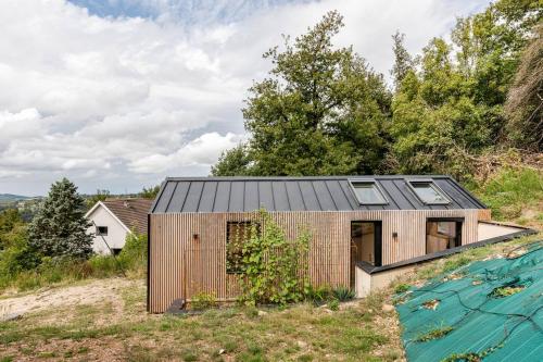 a small house on top of a hill at Cocon nature, clim & home cinéma in Saint-Priest-en-Jarez