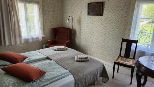 a bedroom with a bed with two pillows on it at Trepimäe Guest Apartment in Viljandi
