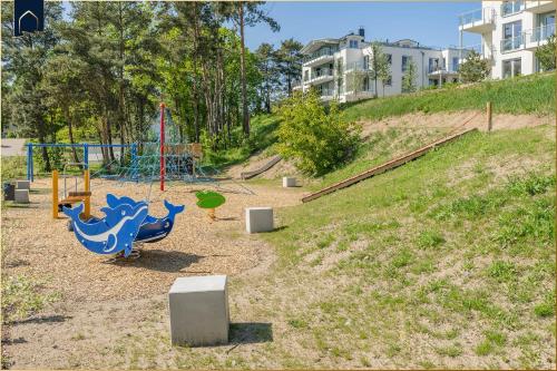 a park with a playground with a blue dinosaur on it at An der Haffküste Haffkoje in Zirchow