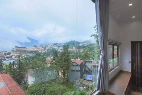 a large window with a view of a city at Sapa Succulent Garden Homestay in Sa Pa