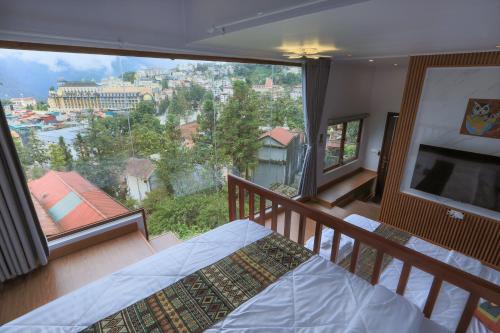 a bedroom with a bed and a large window at Sapa Succulent Garden Homestay in Sa Pa