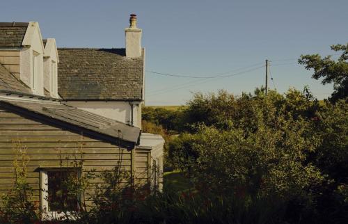 an old house with a chimney on top of it at Tigh na Bruthaich in Stenscholl