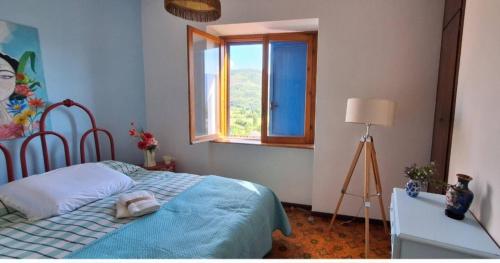 a bedroom with a bed and a window at La Porta Azzurra 