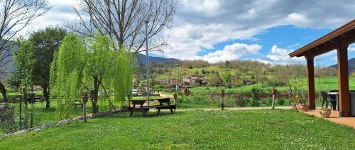 a park with a picnic table in the grass at La Porta Azzurra 
