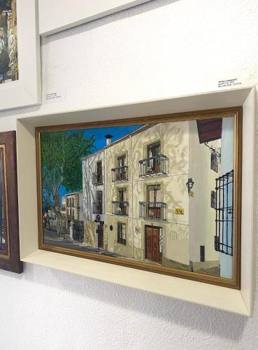 a painting of a building on a wall at Balcones con Encanto - vistas al conjunto monumental Patrimonio de la Humanidad in Úbeda