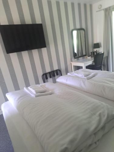 Postel nebo postele na pokoji v ubytování Bandholm Badehotel