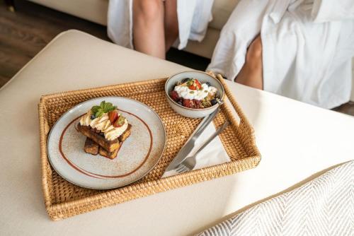 a table with a plate of food and a bowl of dessert at Elements Suites in Middlezoy