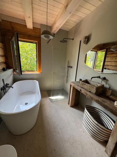 a large bathroom with a tub and a sink at Dom w sadzie 