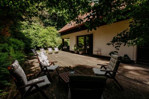 a group of chairs sitting on a patio at Dom Puchacza w Lądku-Zdroju in Lądek-Zdrój