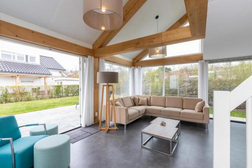 a living room with a couch and chairs at Welcome in - Strandvilla's dichtbij het strand - Vakantiepark Zonnedorp Renesse in Renesse