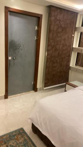 a bedroom with a sliding glass door and a bed at Zm apartment shehab Vib in Cairo
