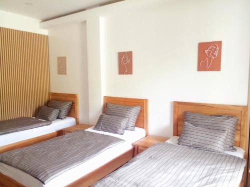 two twin beds in a room withermottermottermott at U And Me in Panglao