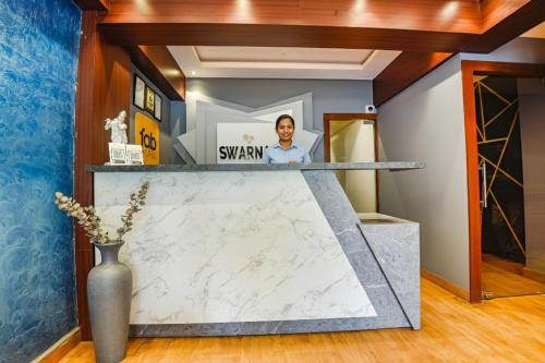 a counter in a room with a marble counter top at FabHotel Prime Swarnam, Old Goa in Old Goa