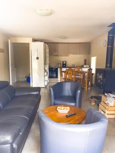 a living room with a couch and a table at Gite du mazel in Naussac