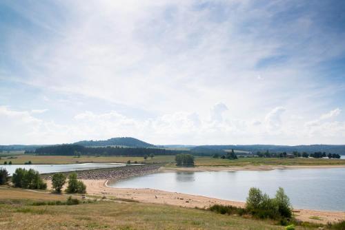 a view of a body of water in a field at Gite du mazel in Naussac
