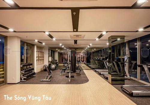 a gym with rows of treadmills and exercise equipment at The Song Your House Apartment - Căn Hộ Du Lịch Biển Vũng Tàu in Vung Tau