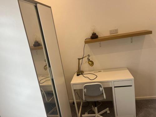 a dressing room with a desk and a mirror at George Guest House in Stoke on Trent