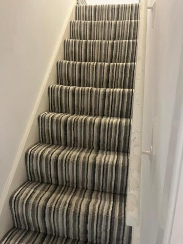 a spiral staircase in a home with a stair case at George Guest House in Stoke on Trent