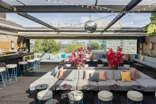 a patio with couches and tables and chairs at Hotel AMANO East Side in Berlin