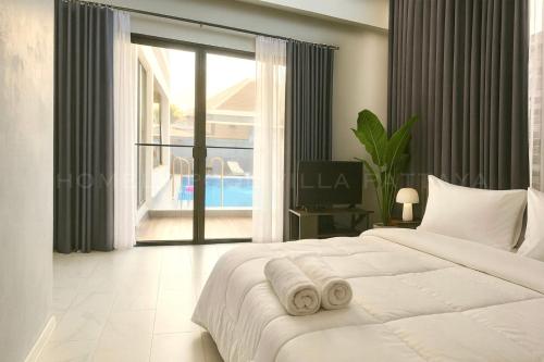Ένα ή περισσότερα κρεβάτια σε δωμάτιο στο pattaya homely pool villa