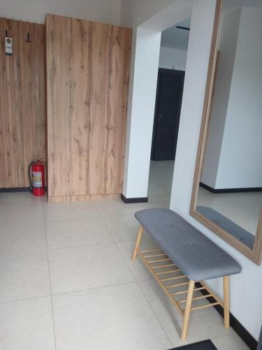 a bench sitting in a room with a mirror at EcoBerghaus - Котеджне містечко in Bukovel
