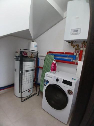 a laundry room with a washing machine and a washer at EcoBerghaus - Котеджне містечко in Bukovel