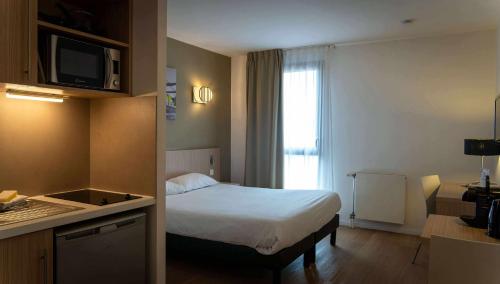 Postel nebo postele na pokoji v ubytování Aparthotel Adagio Access Le Havre Les Docks