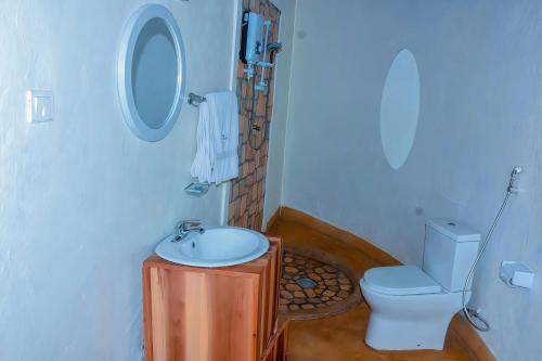 a bathroom with a sink and a toilet at Muhazi Flowers Beach & Resorts in Rwamagana