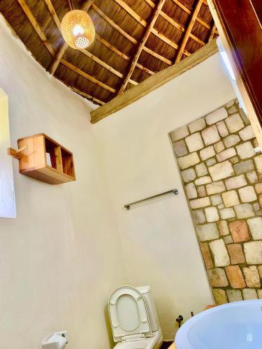a bathroom with a toilet and a sink at Muhazi Flowers Beach & Resorts in Rwamagana