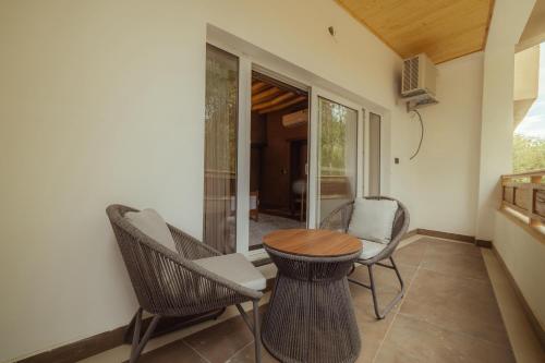 a patio with chairs and a table and a table at Hotel The Kaal in Leh