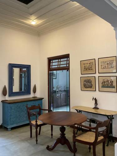 a room with a table and chairs and a mirror at Villa Sea Wave in Hikkaduwa