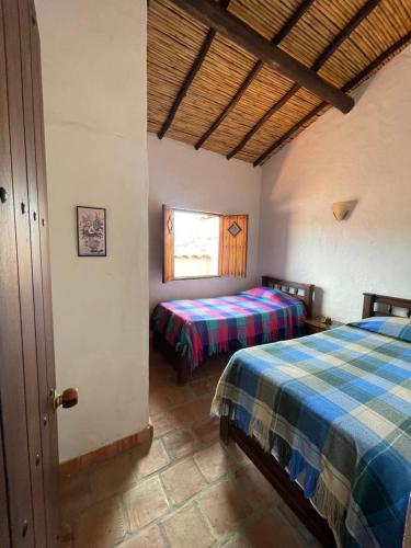 Ένα ή περισσότερα κρεβάτια σε δωμάτιο στο Rustic and Natural Posada Lengerke in Zapatoca