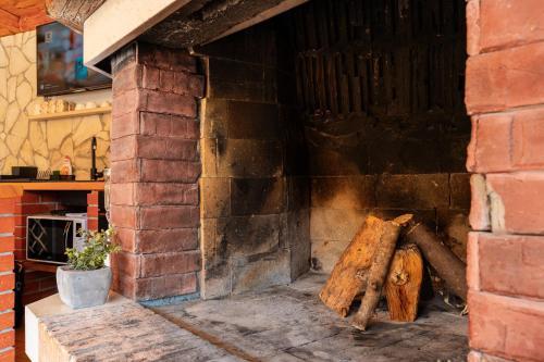 a brick oven with a pile of wood in it at Apartman Mirakul in Korčula
