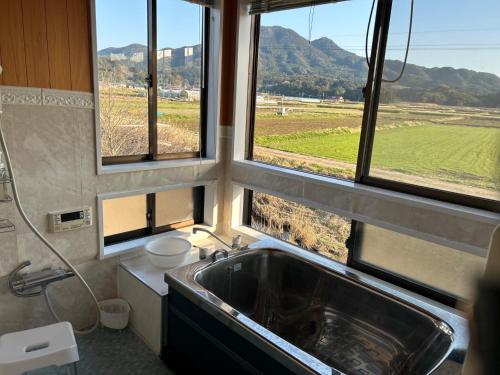 a bathroom with a sink and a view of a field at Farm Stay Umemura - Vacation STAY 21213v in Imari
