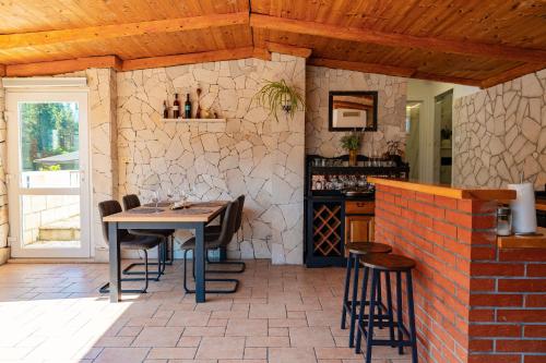 a patio with a table and chairs in a room at Apartman Mirakul in Korčula