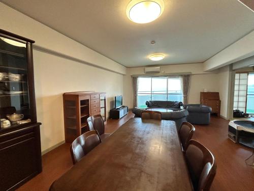 a large living room with a table and a couch at Went Members only Resort Condominium in Sumoto