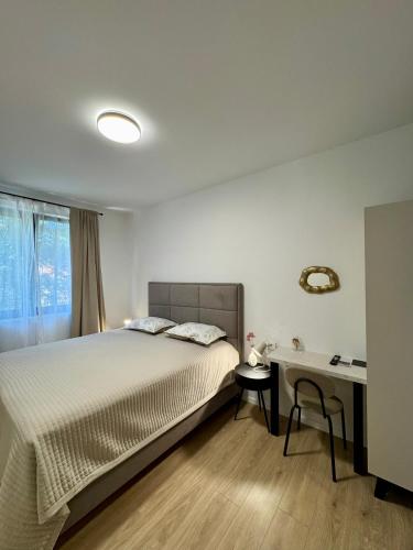 a bedroom with a bed and a desk at Villa D Cube in Kremena