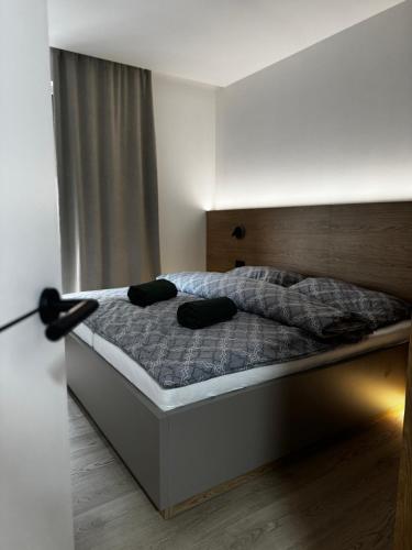 a bedroom with a bed with two pillows on it at Apartmán DANIEL in Spišská Nová Ves