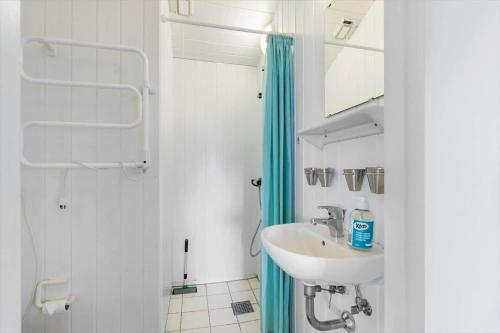 a white bathroom with a sink and a shower at LN2020-Hjorring-Fjorden-2 in Lønstrup