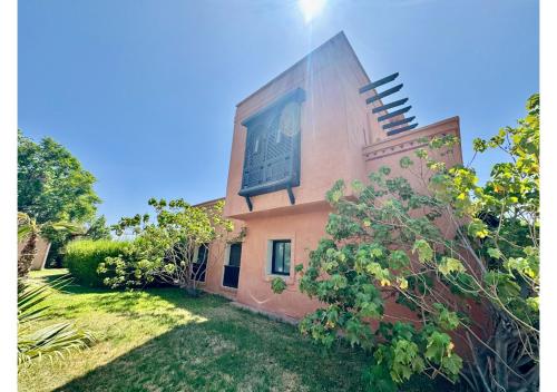 a building with a sign on the side of it at Duplex Luxe avec Rooftop, 3 Piscines, 2 Chambres, Atlas Golf Marrakech in Marrakech