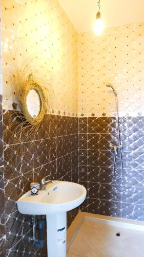 a bathroom with a sink and a shower at Villa Shahinaz 4 chambres, piscine & vue forêt in Essaouira