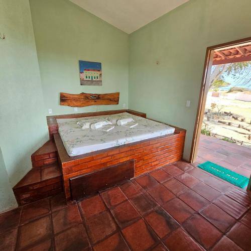 a bedroom with a bed in the corner of a room at Pousada Mae Natureza Icapuí in Icapuí